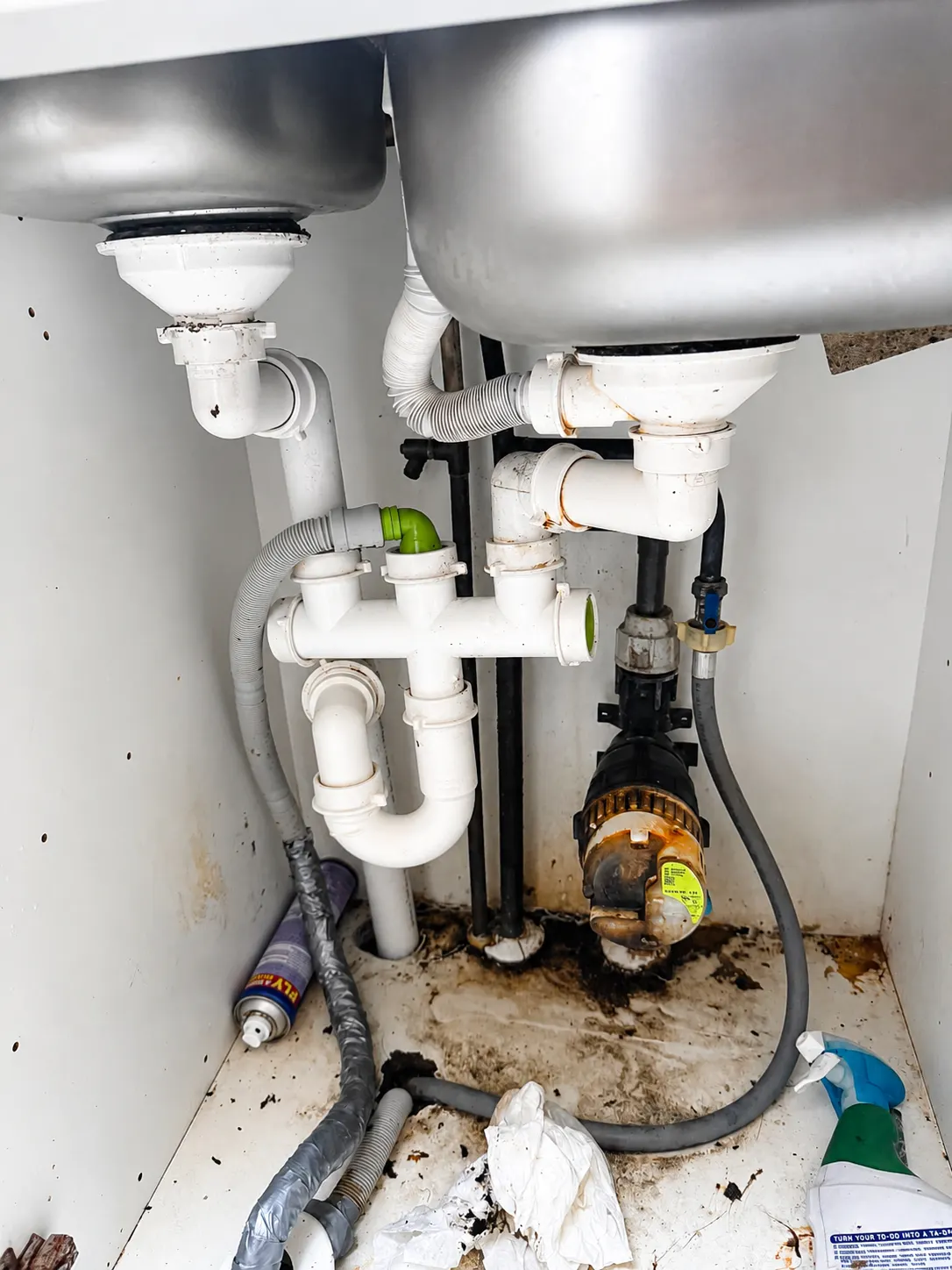 Under-sink leak repair with new isolation valves fitted in a kitchen cupboard