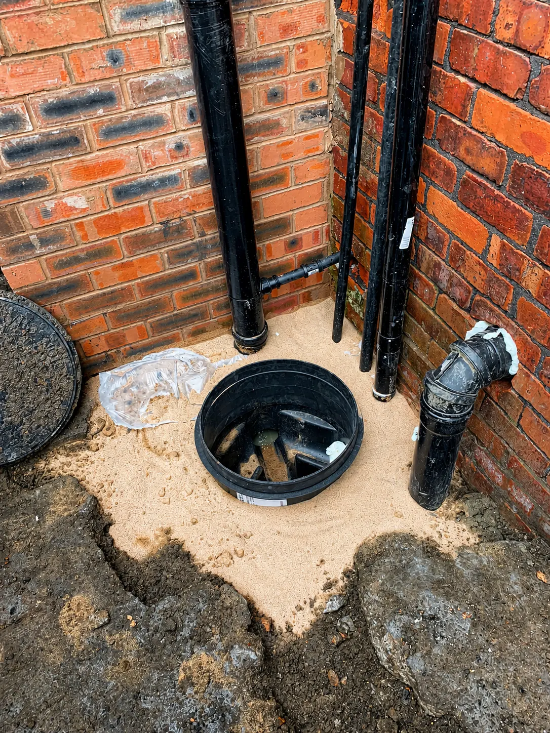 New drainage chamber and pipework installed in a rear yard in Oldham