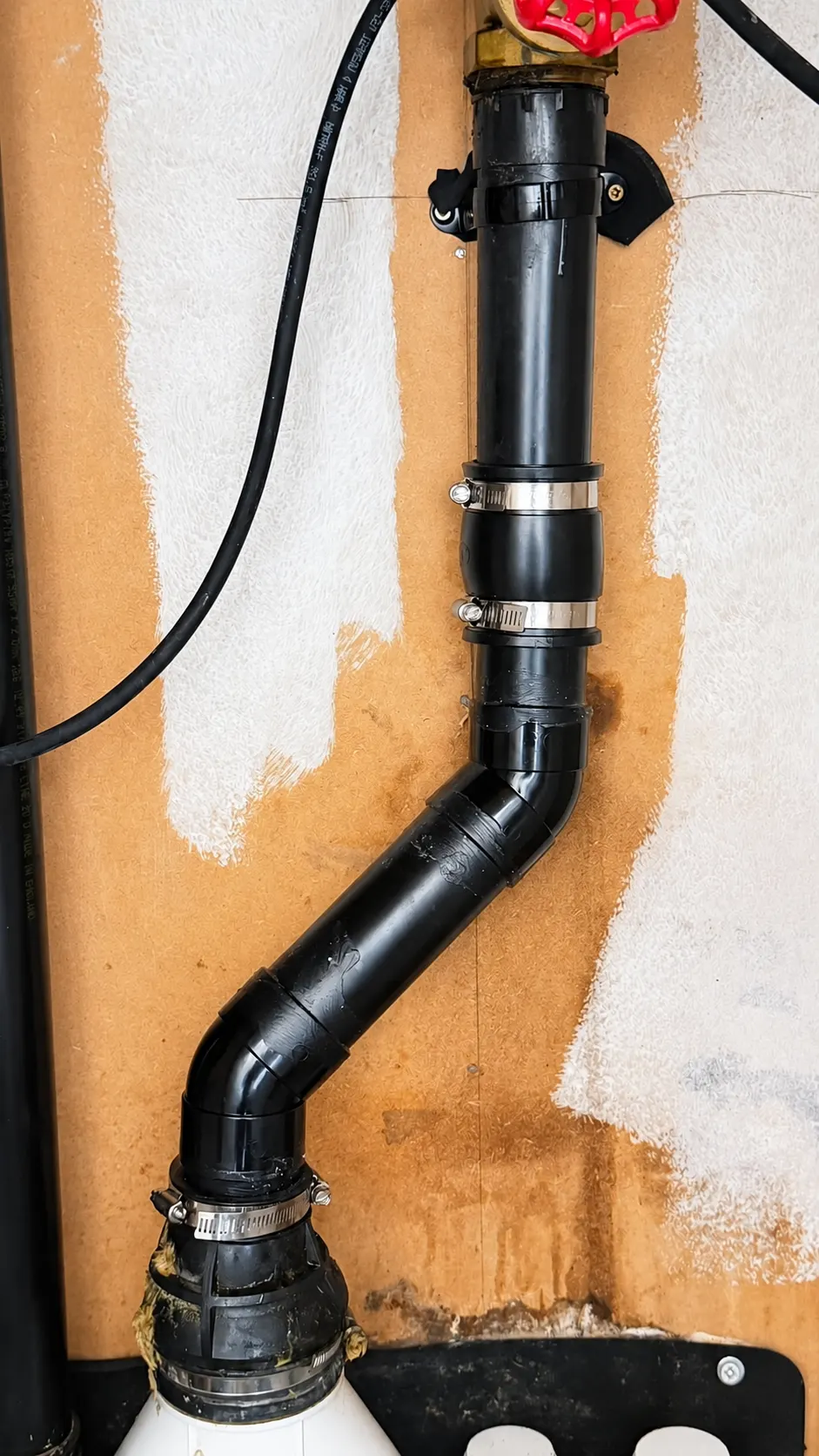 External waste pipework replaced and clipped to a wall in Greater Manchester