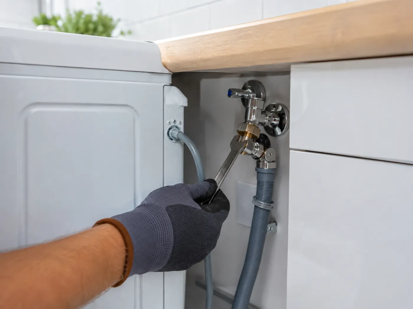 Washing machine and dishwasher water connections plumbed in under a kitchen worktop