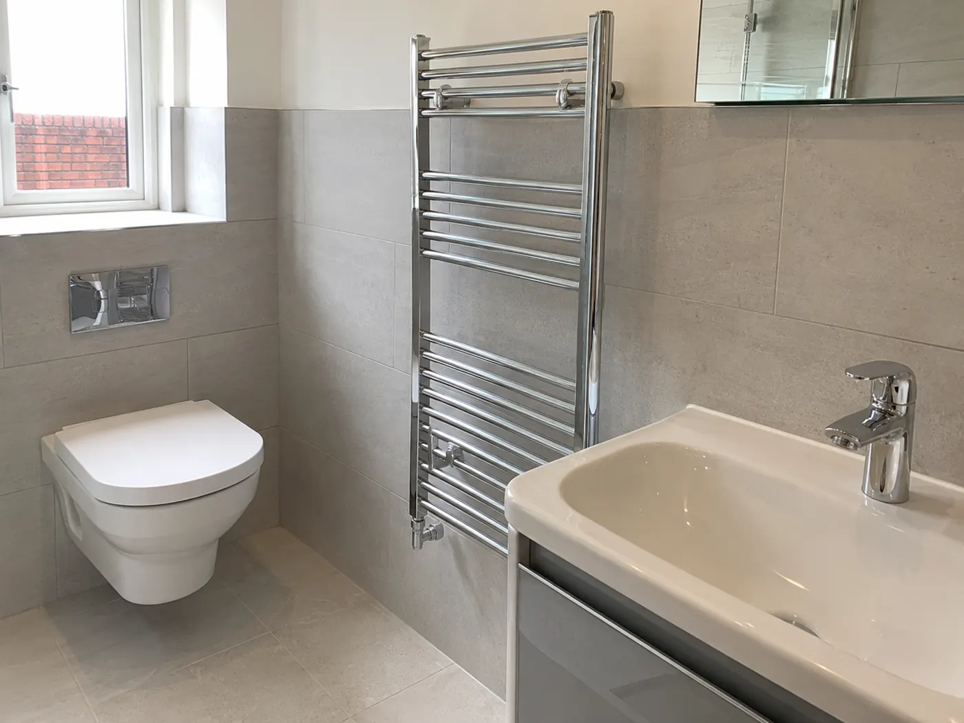 Newly installed bathroom basin and waste pipework fitted by a Manchester plumber